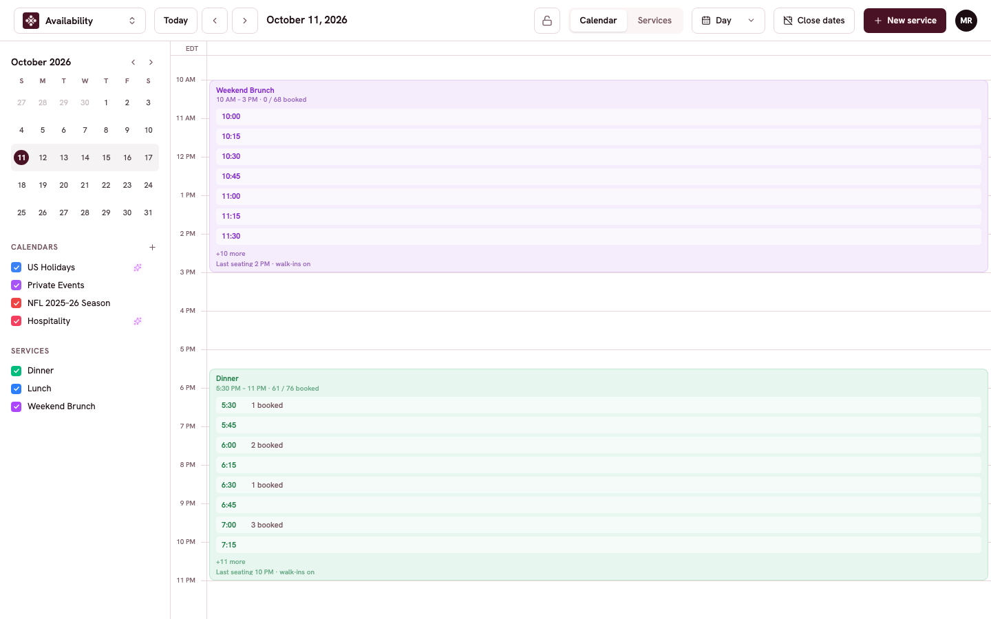 The day view showing Lunch and Dinner cards with booking counts for each time slot